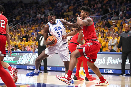 Pittsburgh Panthers Federiko Federiko (33) gets fouled by Louisville Cardinals Sydney Curry (21) while driving to the basket during the first half on February 7, 2023 at the Petersen Events Center in Pittsburgh, PA.

Pittsburgh Panthers Vs Louisville Mens Basketball