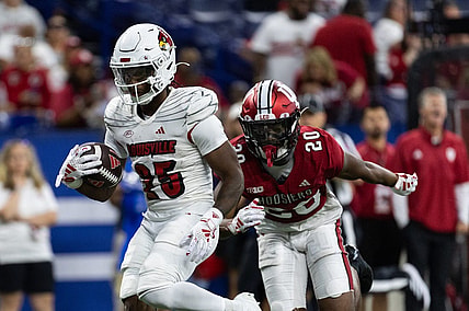 Sep 16, 2023; Indianapolis, Indiana, USA; Louisville Cardinals running back Jawhar Jordan (25) runs for a touchdown against Indiana Hoosiers defensive back Louis Moore (20) in the second quarter at Lucas Oil Stadium. Mandatory Credit: Trevor Ruszkowski-USA TODAY Sports