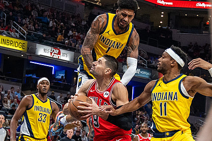 Oct 30, 2023; Indianapolis, Indiana, USA; Chicago Bulls center Nikola Vucevic (9) shoots the ball while Indiana Pacers forward Obi Toppin (1) and forward Bruce Brown (11) defend in the first quarter at Gainbridge Fieldhouse. Mandatory Credit: Trevor Ruszkowski-USA TODAY Sports