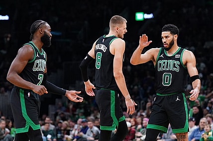 Nov 13, 2023; Boston, Massachusetts, USA; Boston Celtics forward Jayson Tatum (0), center Kristaps Porzingis (8) and guard Jaylen Brown (7) react after a play against th eNew York Knicks in the second quarter at TD Garden. Mandatory Credit: David Butler II-USA TODAY Sports