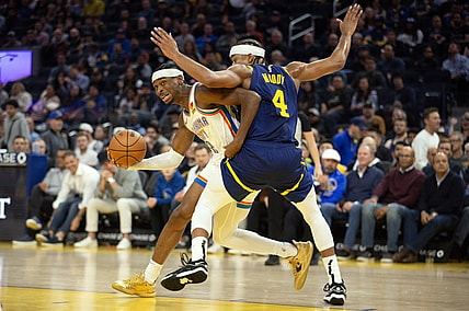 Nov 16, 2023; San Francisco, California, USA; Oklahoma City Thunder guard Shai Gilgeous-Alexander (2) commits an offensive foul on Golden State Warriors guard Moses Moody (4) during the second quarter at Chase Center. Mandatory Credit: D. Ross Cameron-USA TODAY Sports