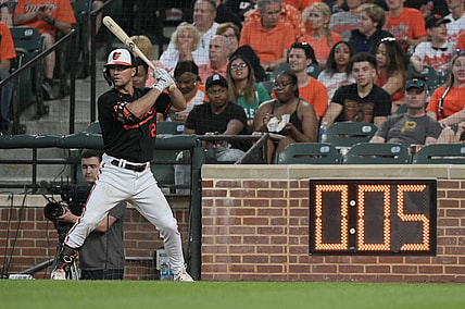 May 12, 2023; Baltimore, Maryland, USA;  Baltimore Orioles second baseman Adam Frazier (12) warms up next to the pitch clock during the third inning of the game against the Pittsburgh Pirates at Oriole Park at Camden Yards. Mandatory Credit: Tommy Gilligan-USA TODAY Sports