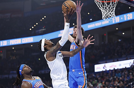 Dec 26, 2023; Oklahoma City, Oklahoma, USA; Minnesota Timberwolves forward Jaden McDaniels (3) is defended by Oklahoma City Thunder forward Chet Holmgren (7) on a shot during the first quarter at Paycom Center. Mandatory Credit: Alonzo Adams-USA TODAY Sports