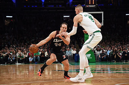 Dec 28, 2023; Boston, Massachusetts, USA;  Detroit Pistons forward Bojan Bogdanovic (44) controls the ball while Boston Celtics center Kristaps Porzingis (8) defends during the second half at TD Garden. Mandatory Credit: Bob DeChiara-USA TODAY Sports