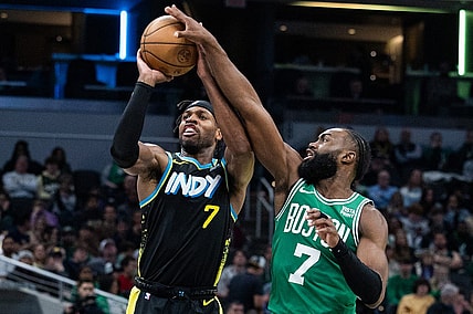 Jan 6, 2024; Indianapolis, Indiana, USA; Boston Celtics guard Jaylen Brown (7) blocks a shot by Indiana Pacers guard Buddy Hield (7) in the second half at Gainbridge Fieldhouse. Mandatory Credit: Trevor Ruszkowski-USA TODAY Sports