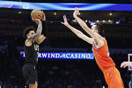 Dec 11, 2023; Oklahoma City, Oklahoma, USA; Utah Jazz guard Keyonte George (3) shoot a three-point basket as Oklahoma City Thunder forward Aleksej Pokusevski (17) defends during the second half at Paycom Center. Mandatory Credit: Alonzo Adams-USA TODAY Sports