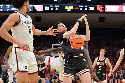 Feb 27, 2024; Dayton, Ohio, USA;  Davidson Wildcats guard Riccardo Ghedini (22) reaches for a rebound against Dayton Flyers forward Nate Santos (2) during the game at University of Dayton Arena. Mandatory Credit: Matt Lunsford-USA TODAY Sports