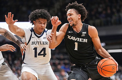 Xavier Musketeers guard Desmond Claude (1) rushes past Butler Bulldogs guard Landon Moore (14) on Wednesday, March 6, 2024, during the game at Hinkle Fieldhouse in Indianapolis. The Butler Bulldogs defeated the Xavier Musketeers, 72-66.