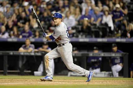 Sep 25, 2015; Denver, CO, USA; Los Angeles Dodgers third baseman Chase Utley (26) doubles in the fifth inning against the Colorado Rockies at Coors Field. Mandatory Credit: Ron Chenoy-USA TODAY Sports