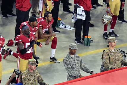 Eric Reid and Colin Kaepernick kneel during the anthem