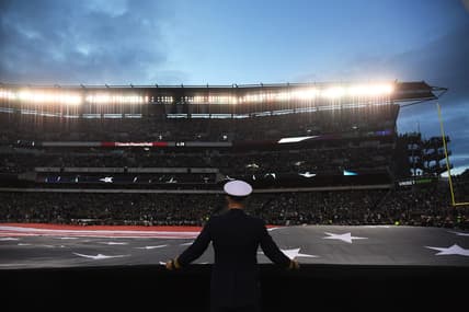 United States flag presented before NFL Playoff game.