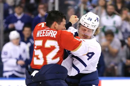 Feb 27, 2020; Sunrise, Florida, USA; Florida Panthers defenseman MacKenzie Weegar (52) fights Toronto Maple Leafs right wing Kasperi Kapanen (24) during the first period of the game at BB&T Center. Mandatory Credit: Sam Navarro-USA TODAY Sports
