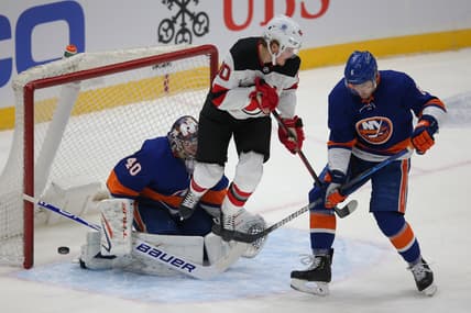 Jan 21, 2021; Uniondale, New York, USA; New York Islanders goalie Semyon Varlamov (40) makes a save against New Jersey Devils center Jesper Boqvist (90) in front of Islanders defenseman Ryan Pulock (6) during the first period at Nassau Veterans Memorial Coliseum. Mandatory Credit: Brad Penner-USA TODAY Sports