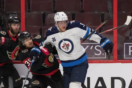 Jan 21, 2021; Ottawa, Ontario, CAN; Ottawa Senators center Colin White (36) is checked by Winnipeg Jets center Andrew Copp (9) in the second period at the Canadian Tire Centre. Mandatory Credit: Marc DesRosiers-USA TODAY Sports