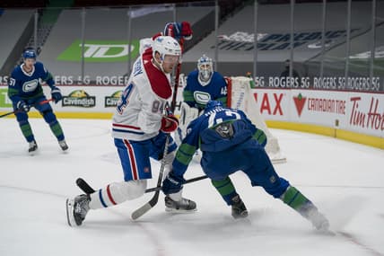 Jan 23, 2021; Vancouver, British Columbia, CAN; Vancouver Canucks defenseman Quinn Hughes (43) checks Montreal Canadiens forward Corey Perry (94) in the first period at Rogers Arena. Mandatory Credit: Bob Frid-USA TODAY Sports