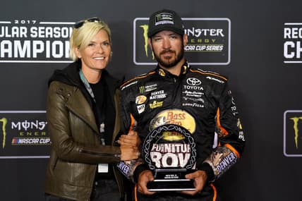 Sep 9, 2017; Richmond, VA, USA; NASCAR Cup Series driver Martin Truex Jr. (78) and his girlfriend Sherry Pollex pose with the NASCAR regular season trophy after the Federated Auto Parts 400 at Richmond International Raceway. Mandatory Credit: Peter Casey-USA TODAY Sports