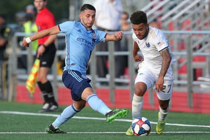 Jun 12, 2019; Queens, NY, USA; North Carolina FC defender DJ Taylor (27) plays the ball against New York City FC midfielder Valentin Castellanos (11) during the first half at Belson Stadium. Mandatory Credit: Brad Penner-USA TODAY Sports
