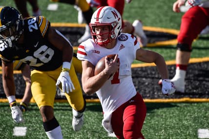 Nov 27, 2020; Iowa City, Iowa, USA; Nebraska Cornhuskers quarterback Luke McCaffrey (7) runs the ball as Iowa Hawkeyes defensive back Kaevon Merriweather (26) gives chase during the first quarter at Kinnick Stadium. Mandatory Credit: Jeffrey Becker-USA TODAY Sports