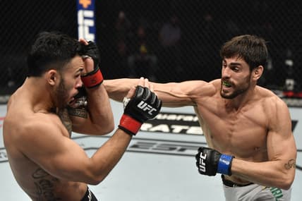 Jan 23, 2021; Abu Dhabi, United Arab Emirates; Antonio Carlos Junior of Brazil punches Brad Tavares in a middleweight fight during the UFC 257 event inside Etihad Arena on UFC Fight Island.  Mandatory Credit: Jeff Bottari/Handout Photo via USA TODAY Sports