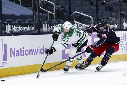 Feb 4, 2021; Columbus, Ohio, USA; Dallas Stars defenseman Esa Lindell (23) passes the puck against Columbus Blue Jackets right wing Patrik Laine (29) in the first period at Nationwide Arena. Mandatory Credit: Aaron Doster-USA TODAY Sports