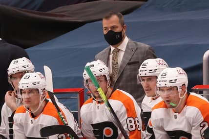 Feb 7, 2021; Washington, District of Columbia, USA; Philadelphia Flyers head coach Alain Vigneault (M) looks on from behind the bench against the Washington Capitals in the third period at Capital One Arena. Mandatory Credit: Geoff Burke-USA TODAY Sports