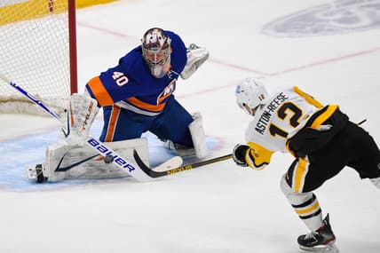 Feb 11, 2021; Uniondale, New York, USA; New York Islanders goaltender Semyon Varlamov (40) makes a save against Pittsburgh Penguins forward Zach Aston-Reese (12) during the first period between the New York Islanders and the Pittsburgh Penguins at Nassau Veterans Memorial Coliseum. Mandatory Credit: Dennis Schneidler-USA TODAY Sports