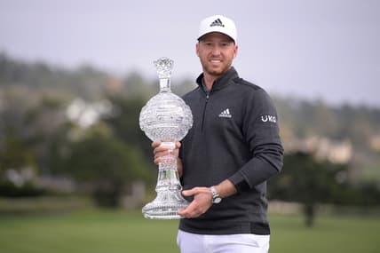 Feb 14, 2021; Pebble Beach, California, USA; Daniel Berger poses with the winner's trophy after the final round of the AT&T Pebble Beach Pro-Am golf tournament at Pebble Beach Golf Links. Mandatory Credit: Orlando Ramirez-USA TODAY Sports