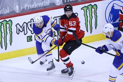 Feb 20, 2021; Newark, New Jersey, USA; Buffalo Sabres defenseman William Borgen (3) passes the puck against New Jersey Devils left wing Jesper Bratt (63) during the first period at Prudential Center. Mandatory Credit: Vincent Carchietta-USA TODAY Sports