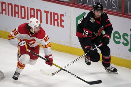 Feb 27, 2021; Ottawa, Ontario, CAN; Calgary Flamesleft wing Andrew Mangiapane (88) chases Ottawa Senators right wing Drake Batherson (19) in the third period at the Canadian Tire Centre. Mandatory Credit: Marc DesRosiers-USA TODAY Sports