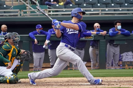 Feb 28, 2021; Mesa, Arizona, USA; Los Angeles Dodgers shortstop Corey Seager (5) hits a RBI single against the Oakland Athletics in the third inning at Hohokam Stadium. Mandatory Credit: Rick Scuteri-USA TODAY Sports