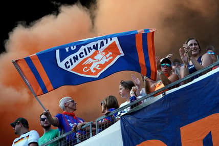 Jul 21, 2019; Cincinnati, OH, USA; A fan of FC Cincinnati waves a team flag in support prior to the game against the New England Revolution at Nippert Stadium. Mandatory Credit: Aaron Doster-USA TODAY Sports