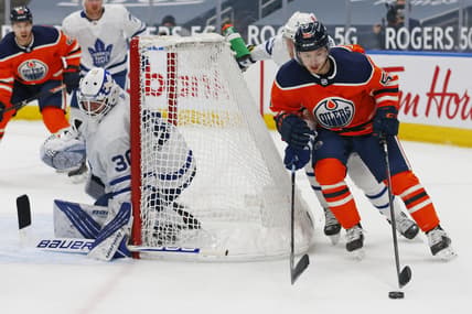 Mar 1, 2021; Edmonton, Alberta, CAN; Edmonton Oilers forward Kailer Yamamoto (56) moves the puck behind Toronto Maple Leafs goaltender Michael Hutchinson (30) during the third period at Rogers Place. Mandatory Credit: Perry Nelson-USA TODAY Sports