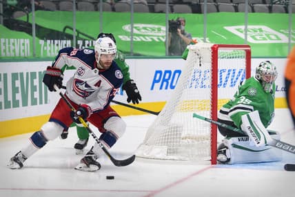 Mar 4, 2021; Dallas, Texas, USA; Columbus Blue Jackets center Boone Jenner (38) skates against the Stars as Dallas Stars goaltender Anton Khudobin (35) defends the goal during the first period at the American Airlines Center. Mandatory Credit: Jerome Miron-USA TODAY Sports