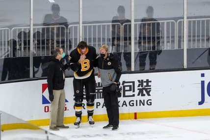 Mar 5, 2021; Boston, Massachusetts, USA; Boston Bruins defenseman Brandon Carlo (25) reacts after suffering an apparent injury against the Washington Capitals during the first period at TD Garden. Mandatory Credit: Paul Rutherford-USA TODAY Sports