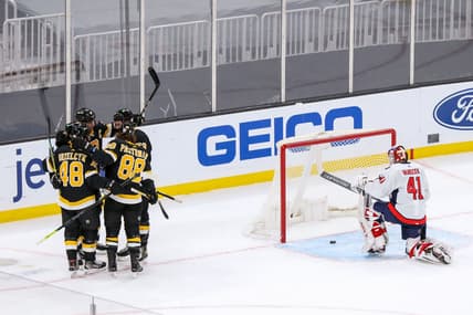 Mar 5, 2021; Boston, Massachusetts, USA; The Boston Bruins celebrate after a goal by left wing Brad Marchand (63) against Washington Capitals goalie Vitek Vanecek (41) during the second period at TD Garden. Mandatory Credit: Paul Rutherford-USA TODAY Sports