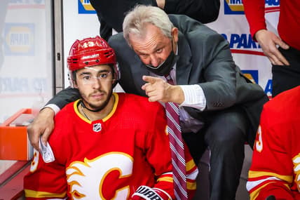 Mar 13, 2021; Calgary, Alberta, CAN; Calgary Flames head coach Darryl Sutter on his bench with left wing Johnny Gaudreau (13) during the third period against the Montreal Canadiens at Scotiabank Saddledome. Mandatory Credit: Sergei Belski-USA TODAY Sports
