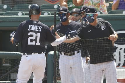 Mar 16, 2021; Lakeland, Florida, USA;  Detroit Tigers left fielder JaCoby Jones (21) is congratulated by manager A.J. Hinch (14) as je hits a home run during the second inning against the New York Yankees at Publix Field at Joker Marchant Stadium. Mandatory Credit: Kim Klement-USA TODAY Sports