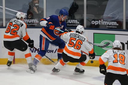Mar 18, 2021; Uniondale, New York, USA; New York Islanders center Brock Nelson (29) fights for the puck against Philadelphia Flyers right wing Nicolas Aube-Kubel (62) and defenseman Erik Gustafsson (56) during the first period at Nassau Veterans Memorial Coliseum. Mandatory Credit: Brad Penner-USA TODAY Sports