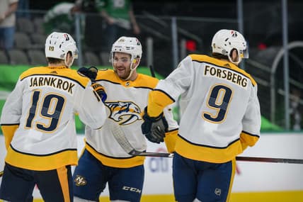 Mar 21, 2021; Dallas, Texas, USA; Nashville Predators center Calle Jarnkrok (19) and defenseman Jeremy Davies (38) and left wing Filip Forsberg (9) celebrate the win over the Dallas Stars at the American Airlines Center. Mandatory Credit: Jerome Miron-USA TODAY Sports