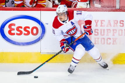 Mar 13, 2021; Calgary, Alberta, CAN; Montreal Canadiens right wing Brendan Gallagher (11) controls the puck against the Calgary Flames during the first period at Scotiabank Saddledome. Mandatory Credit: Sergei Belski-USA TODAY Sports