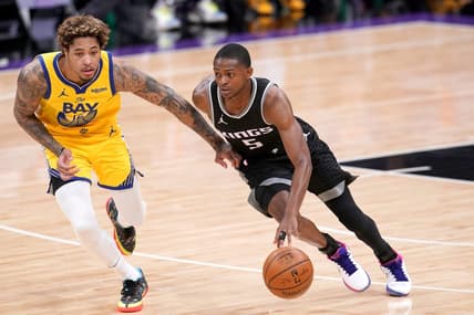 Mar 25, 2021; Sacramento, California, USA; Sacramento Kings guard De'Aaron Fox (5) dribbles past Golden State Warriors forward Kelly Oubre Jr. (12) in the third quarter at the Golden 1 Center. Mandatory Credit: Cary Edmondson-USA TODAY Sports
