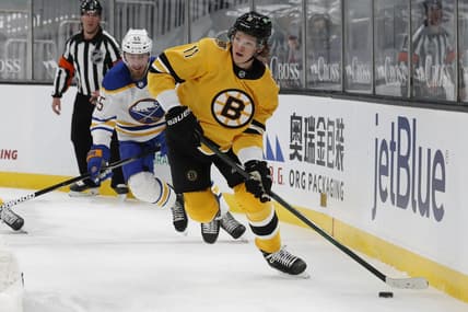 Mar 27, 2021; Boston, Massachusetts, USA; Boston Bruins center Trent Frederic (11) looks to pass as Buffalo Sabres defenseman Rasmus Ristolainen (55) looks on during the first period at TD Garden. Mandatory Credit: Winslow Townson-USA TODAY Sports