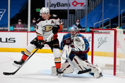 Mar 29, 2021; Denver, Colorado, USA; Anaheim Ducks right wing Jakob Silfverberg (33) attempts to redirect the puck past Colorado Avalanche goaltender Philipp Grubauer (31) in the first period at Ball Arena. Mandatory Credit: Isaiah J. Downing-USA TODAY Sports