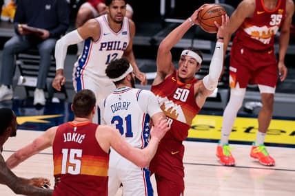 Mar 30, 2021; Denver, Colorado, USA; Denver Nuggets forward Aaron Gordon (50) corns the ball against Philadelphia 76ers guard Seth Curry (31) in the second quarter at Ball Arena. Mandatory Credit: Isaiah J. Downing-USA TODAY Sports