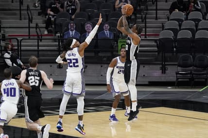 Mar 31, 2021; San Antonio, Texas, USA; San Antonio Spurs forward DeMar DeRozan (10) shoots the ball over Sacramento Kings forward Richaun Holmes (22) as guard Buddy Hield (24) looks on during the third quarter at AT&T Center. Mandatory Credit: Scott Wachter-USA TODAY Sports
