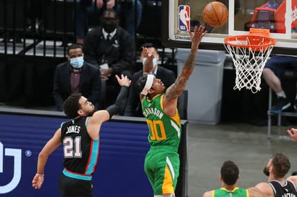 Mar 31, 2021; Memphis, Tennessee, USA; Utah Jazz guard Jordan Clarkson (00) shoots the ball while defended by Memphis Grizzlies guard Tyus Jones (21) during the fourth quarter at FedExForum. Mandatory Credit: Nelson Chenault-USA TODAY Sports