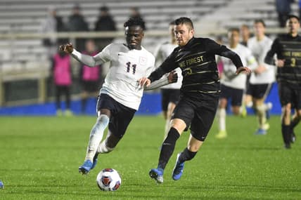 Dec 13, 2019; Cary, NC, USA; Virginia Cavaliers forward Irakoze Donasiyano (11) with the ball as Wake Forest Demon Deacons forward Kyle Holcomb (3) defends in the second half at WakeMed Soccer Park. The Virginia Cavaliers defeated the Wake Forest Demon Deacons 2-1. Mandatory Credit: Bob Donnan-USA TODAY Sports