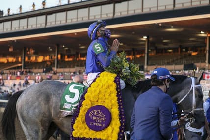 Nov 6, 2020; Lexington, KY, USA; Luis Saez aboard Essential Quality (5) reacts after winning the Breeder's Cup Juvenile race during the 37th Breeders Cup World Championship at Keeneland Race Track. Mandatory Credit: Katie Stratman-USA TODAY Sports