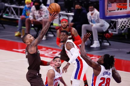 Mar 31, 2021; Detroit, Michigan, USA;  Portland Trail Blazers guard Damian Lillard (0) shoots on Detroit Pistons center Isaiah Stewart (28) in the second half at Little Caesars Arena. Mandatory Credit: Rick Osentoski-USA TODAY Sports