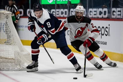 Mar 26, 2021; Washington, District of Columbia, USA; Washington Capitals defenseman Dmitry Orlov (9) and New Jersey Devils right wing Kyle Palmieri (21) during the third period at Capital One Arena. Mandatory Credit: Scott Taetsch-USA TODAY Sports
